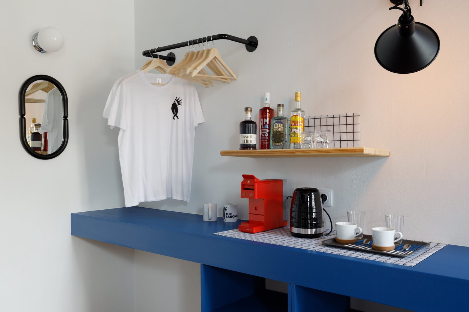 a corner at the baroness 2 showing the mini bar, with the coffe machine, boiler and a hanger for the clothes